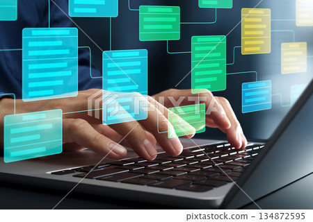 System design and software development. Engineers create class diagrams on their laptops and develop system architectures. 134872595