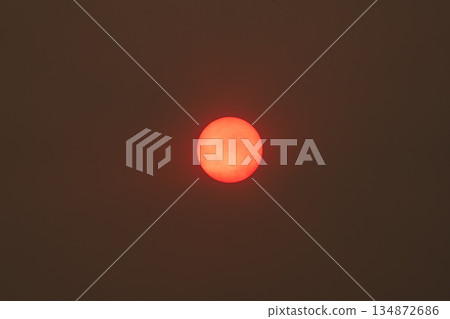 Intense Red Sun in a Smoky Sky Intense Red Sun in a Smoky Sky 134872686