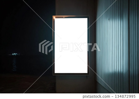 A4 vertical glowing light box mockup template at night. 134872995