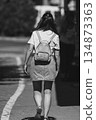 Woman walking on the street 134873363