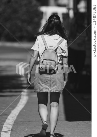 Woman walking on the street 134873363