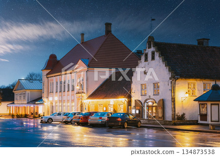 Kuressaare, Estonia. Old Gross Weight Storage Building House Near Market In Tallinna Street At Evening Night. Street In Fesive Christmas Xmas New Year Illuminations. 134873538