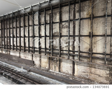 Metal frame for future wall cladding. Wall construction and tiling during renovation. Wall repair work. Authentic construction photography. Concrete wall with metal frame Metal frame for future wall cladding. Wall construction and tiling during renovation. Wall repair work. Authentic construction photography. Concrete wall with metal frame 134873691