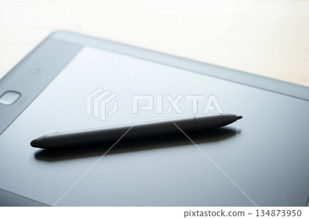 close up of smartphone and pen on laptop 134873950