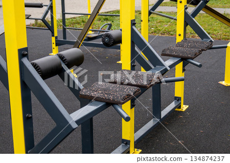 Workout benches are set up at an outdoor gym in a park, ready for exercise sessions during the day Workout benches are set up at an outdoor gym in a park, ready for exercise sessions during the day 134874237