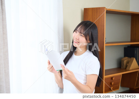 Young woman reading a book 134874450
