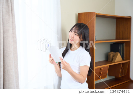 Young woman reading a book 134874451