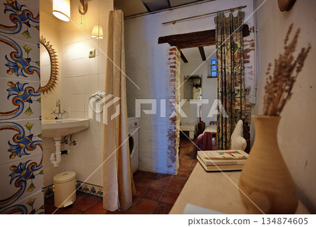 Cozy rustic bathroom and living area in a brick doorway home with vintage decor 134874605