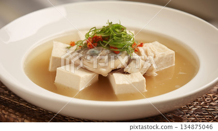 Traditional Chinese Fish Head Soup with Tofu and Scallion Garnish in White Bowl Traditional Chinese Fish Head Soup with Tofu and Scallion Garnish in White Bowl 134875046
