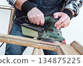 Carpenter at work, restoring an old wooden window. Carpentry. 134875225