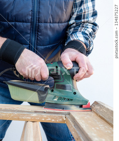 Carpenter at work, restoring an old wooden window. Carpentry. 134875227