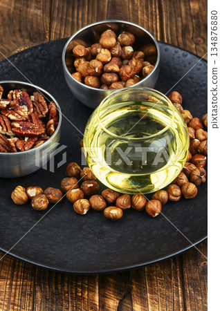 Assorted Nuts with Oil on Plate, Hazelnuts and Pecans Still Life Assorted Nuts with Oil on Plate, Hazelnuts and Pecans Still Life 134876880