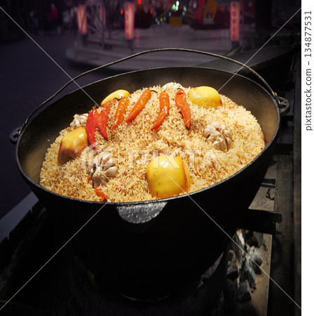 Aromatic pilaf is fried in a cauldron 134877531