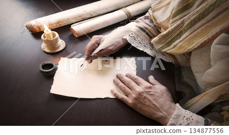 Male hand witn big quill Male hand witn big quill 134877556