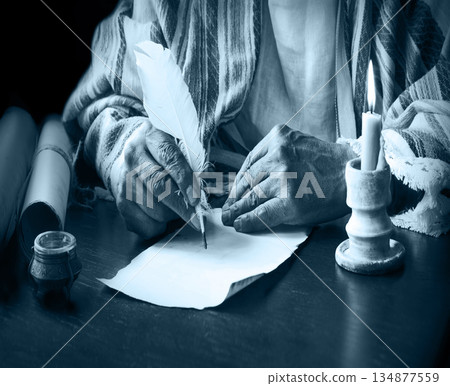Male hand witn big quill Male hand witn big quill 134877559