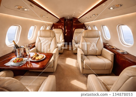 Luxury Private Jet Interior with Leather Seats and Gourmet Food Service 134878053