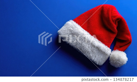 Santa Claus Hat on Blue Background with Copy Space Santa Claus Hat on Blue Background with Copy Space 134878217
