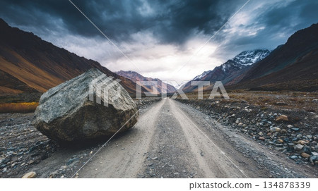 Huge Rock Resting on Gravel Road in Scenic Mountain Valley Huge Rock Resting on Gravel Road in Scenic Mountain Valley 134878339