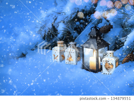 Lanterns in the snow under the Christmas tree Lanterns in the snow under the Christmas tree 134879551