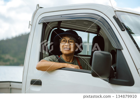 A woman sitting in the driver's seat of a light truck (Photo courtesy of Oki Seaside Resort Miyabi) 134879910