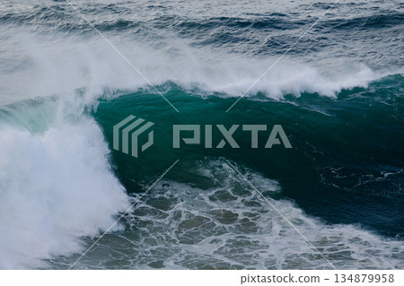 Majestic curling ocean wave crashing with foam and deep turquoise water Majestic curling ocean wave crashing with foam and deep turquoise water 134879958