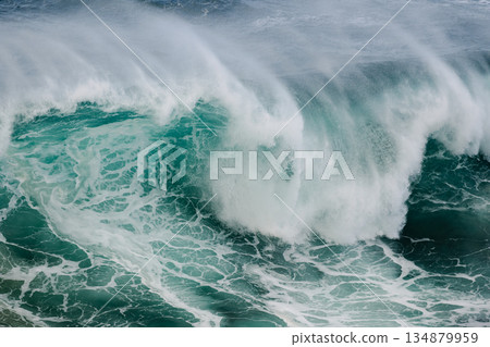 Majestic crashing ocean wave curling with turquoise water and white spray 134879959