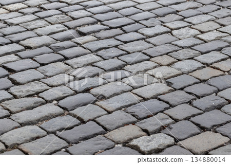 A detailed close-up of weathered gray cobblestone road 134880014
