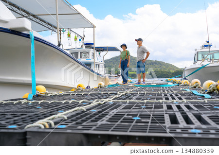 A couple watching the boats on the pier (Photo courtesy of Oki Seaside Resort Miyabi) A couple watching the boats on the pier (Photo courtesy of Oki Seaside Resort Miyabi) 134880339