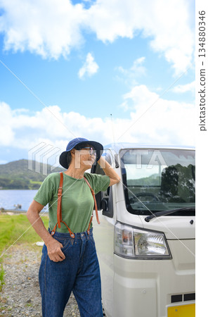 A light truck and a woman traveling [Photography cooperation: Oki Seaside Resort Miyabi] 134880346