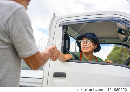 An elderly woman and a light truck (Photo courtesy of Oki Seaside Resort Miyabi) An elderly woman and a light truck (Photo courtesy of Oki Seaside Resort Miyabi) 134880350
