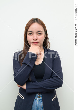 Portrait of a young Asian businesswoman against white background thinking Portrait of a young Asian businesswoman against white background thinking 134880715