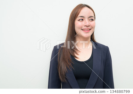 Portrait of a young happy Asian businesswoman against white background thinking Portrait of a young happy Asian businesswoman against white background thinking 134880799