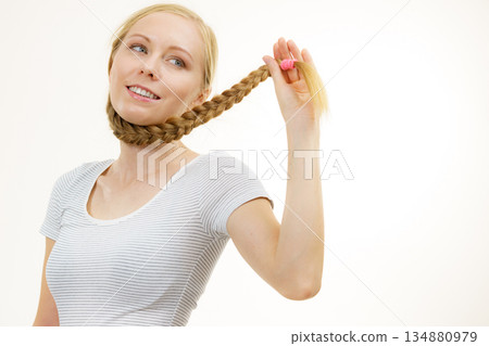 Blonde girl with long braid hair 134880979