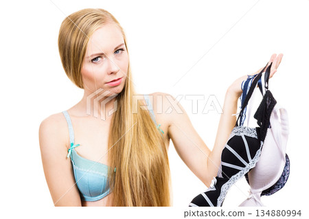 Woman choosing bra to wear Woman choosing bra to wear 134880994