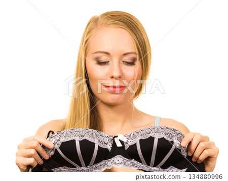 Woman trying on black bra with lace 134880996