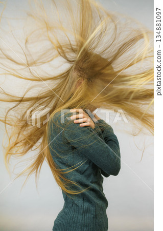 Sad girl with blowing hair Sad girl with blowing hair 134881097