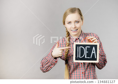 Happy positive woman holding idea sign Happy positive woman holding idea sign 134881127