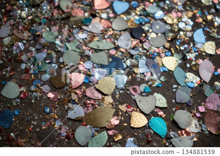 Colorful glitter pieces scattered on a surface 134881539