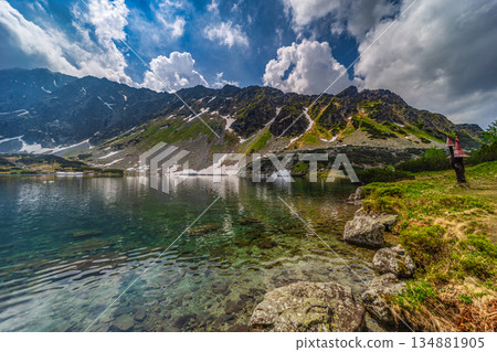 Crystal clear alpine lake with mountain reflections in High Tatras 134881905