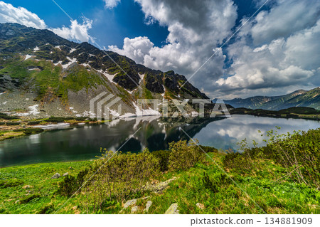 Crystal clear alpine lake with mountain reflections in High Tatras 134881909