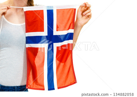 Young woman holding norwegian flag Young woman holding norwegian flag 134882058