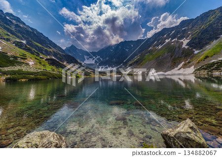 Crystal clear alpine lake with mountain reflections in High Tatras 134882067