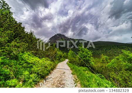 Dramatic storm clouds over a mountain hiking trail in High Tatras Dramatic storm clouds over a mountain hiking trail in High Tatras 134882329