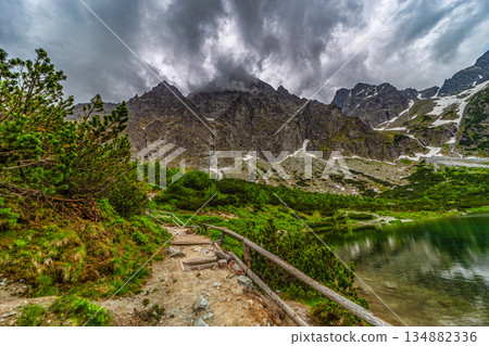 Dark storm clouds over alpine lake Zelene pleso in High Tatras Dark storm clouds over alpine lake Zelene pleso in High Tatras 134882336