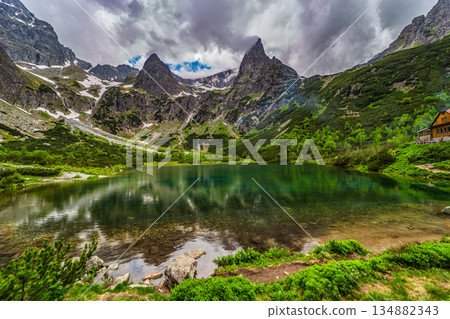 Dark storm clouds over alpine lake Zelene pleso in High Tatras Dark storm clouds over alpine lake Zelene pleso in High Tatras 134882343