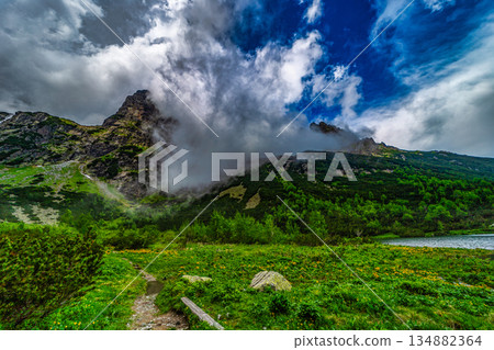 Mist and clouds swirling around Jastrabia veza peak in High Tatras Mist and clouds swirling around Jastrabia veza peak in High Tatras 134882364