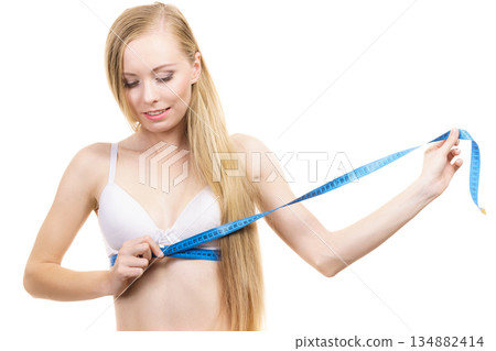 Woman measuring her chest under breast Woman measuring her chest under breast 134882414