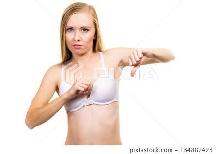 Woman dissatisfied with size of bra breasts 134882423