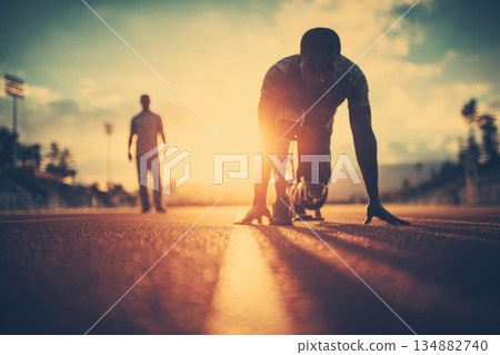 Disabled athlete training on track at sunset with strong support and determination, preparing for race with prosthetic leg and focused mindset 134882740