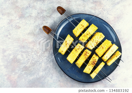 Pineapple on wooden skewer. 134883192